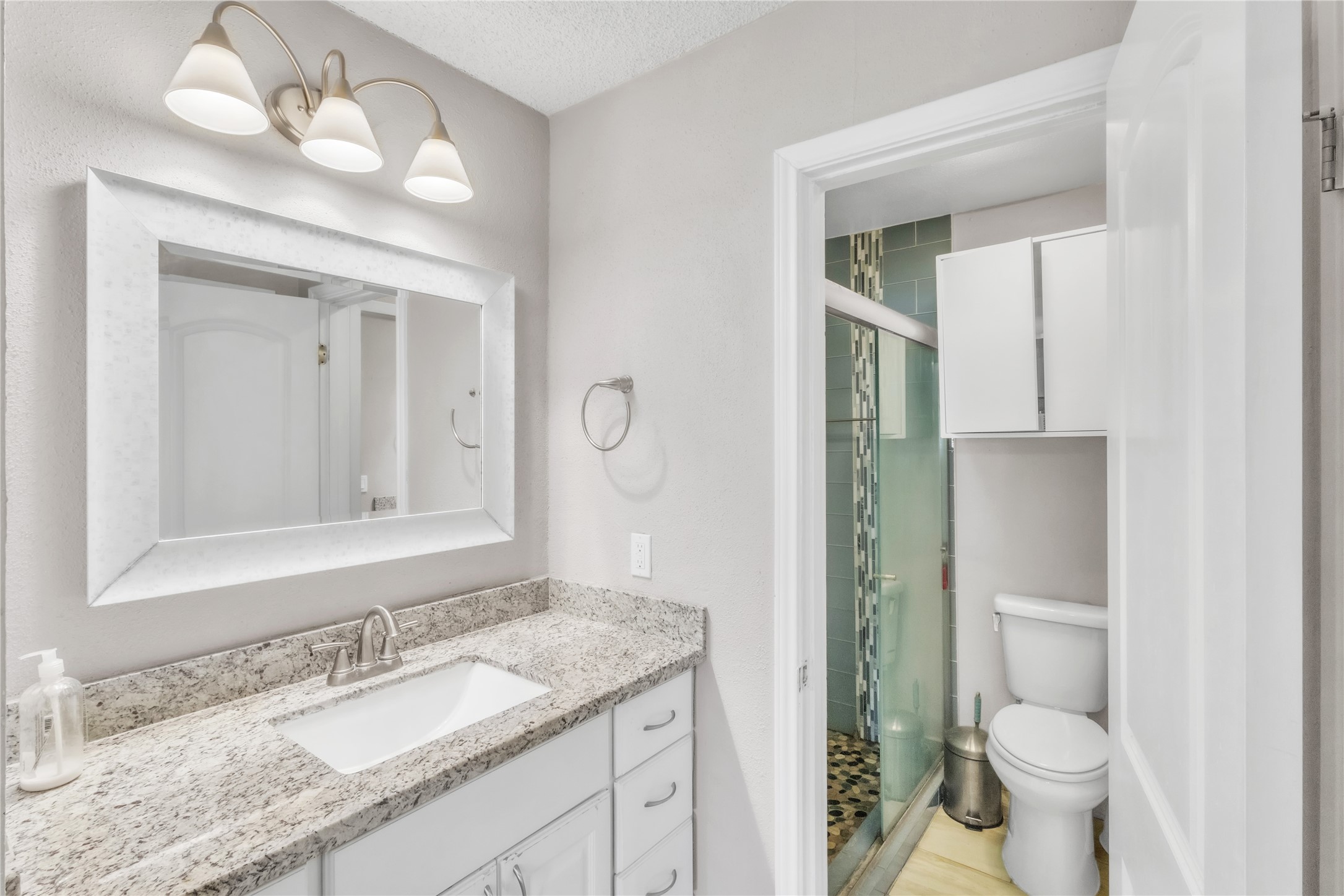 7044 South Dairy Ashford Road Houston, TX 77072 - Photo 20 of 30 a bathroom with a granite countertop sink vanity mirror and toilet