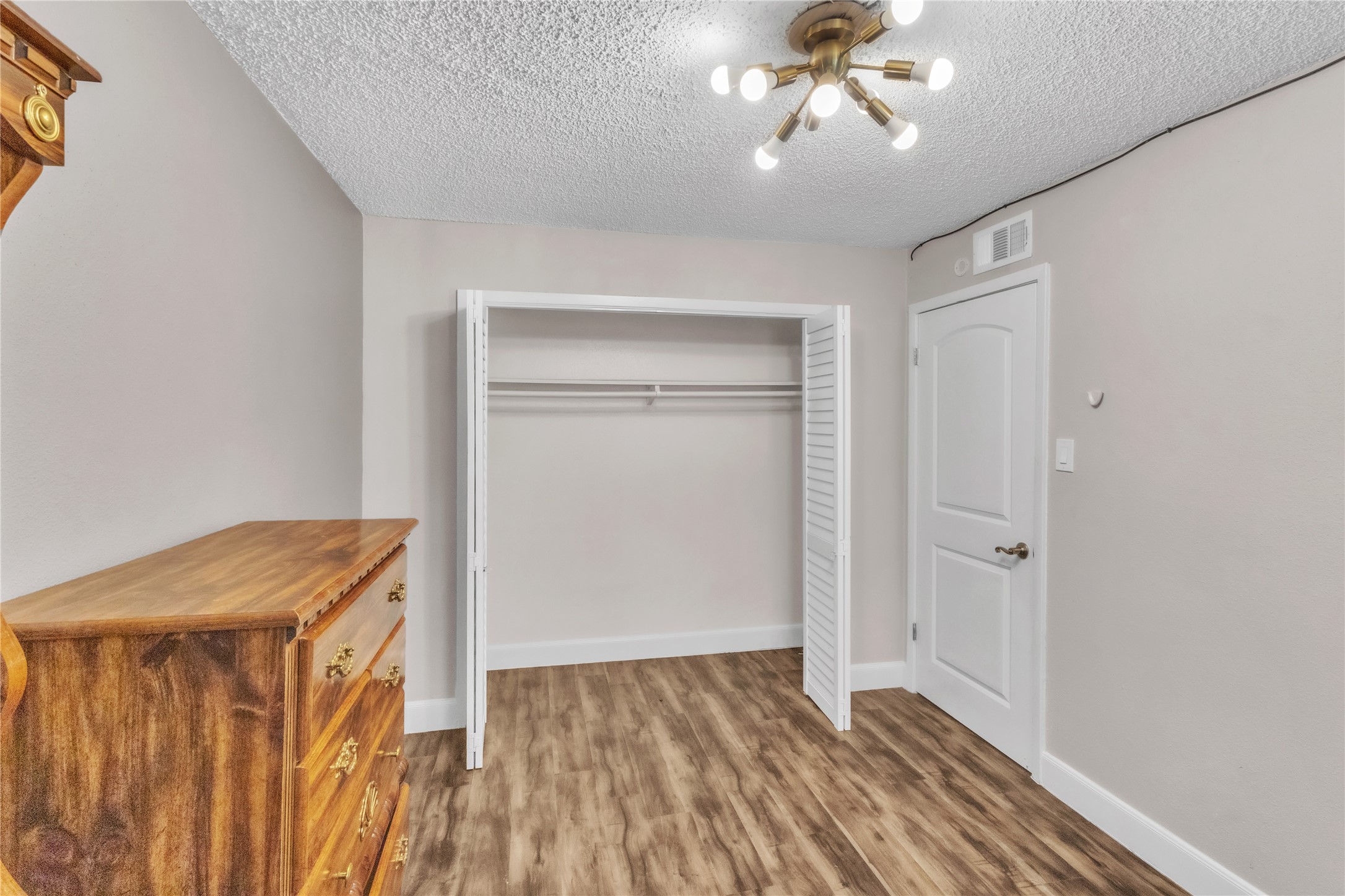7044 South Dairy Ashford Road Houston, TX 77072 - Photo 26 of 30 a view of an empty room with wooden floor and a window