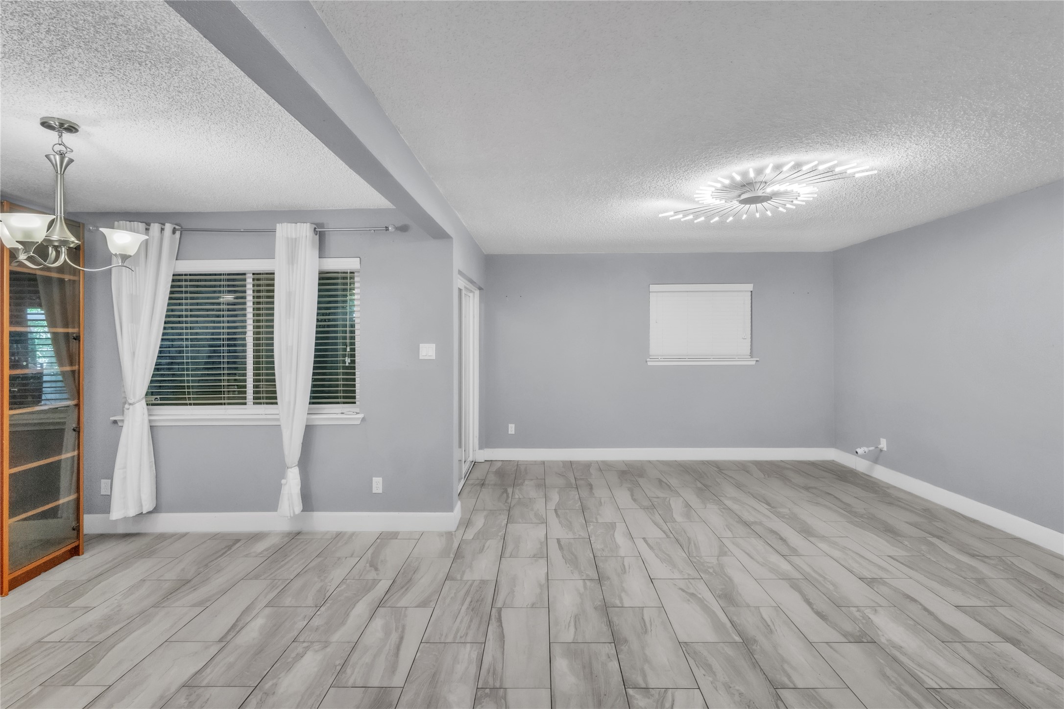 7044 South Dairy Ashford Road Houston, TX 77072 - Photo 9 of 30 an empty room with wooden floor and windows