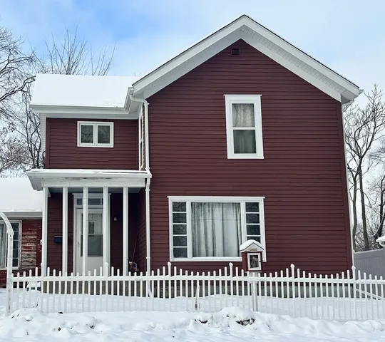 a front view of a house with a fence