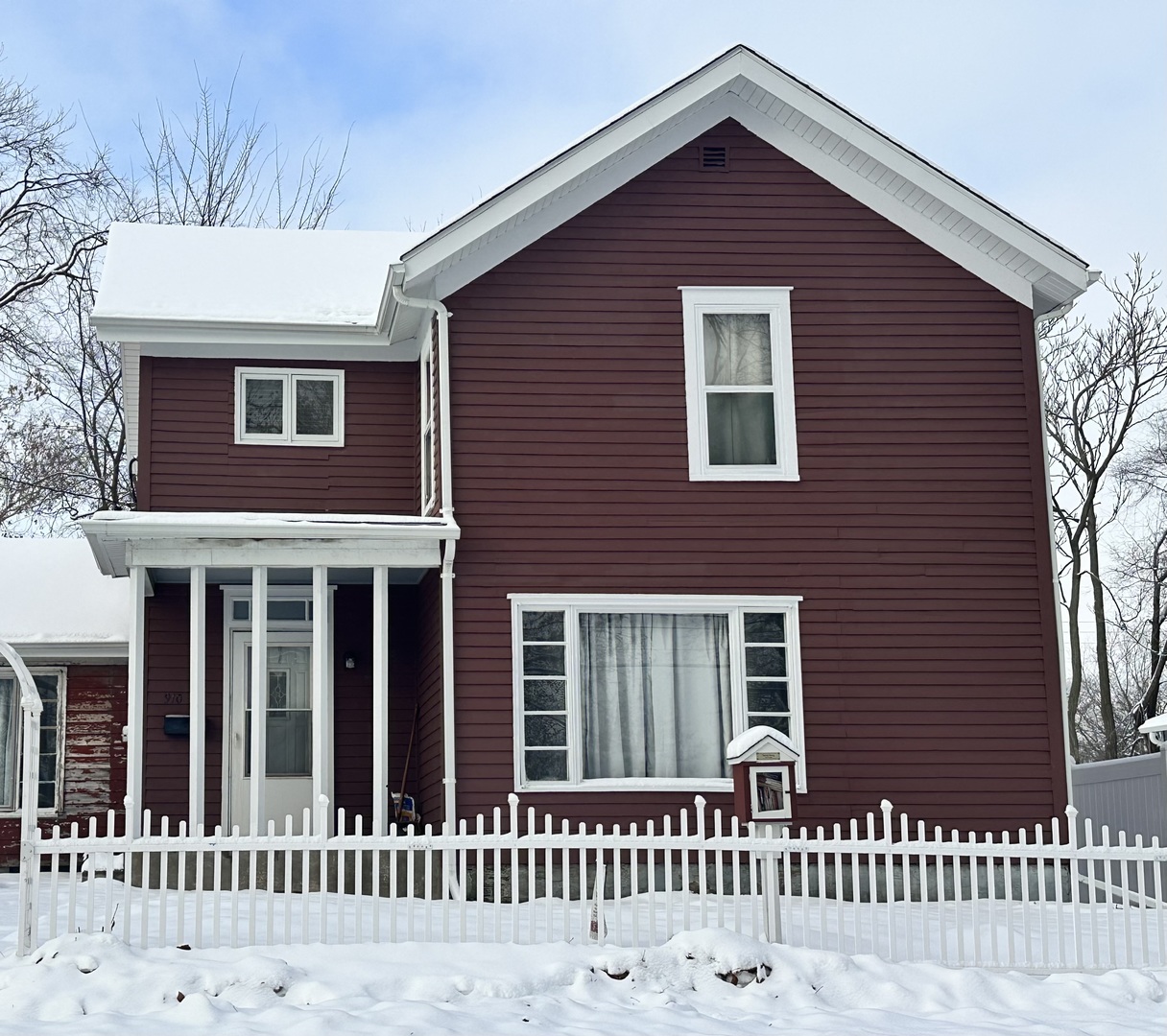 a front view of a house with a fence