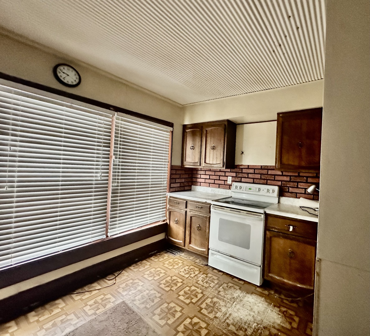 910 North Madison Street Bloomington, IL 61701 - Photo 5 of 11 a kitchen with a stove and white cabinets