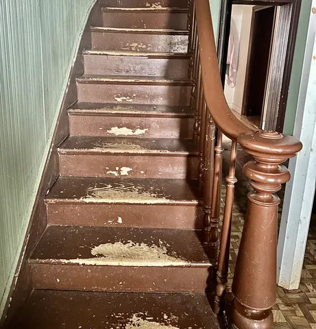 a view of water heater room with wooden floor