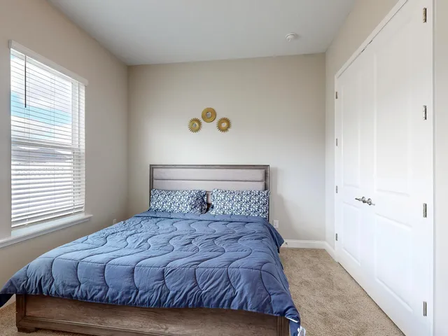 a bedroom with a bed and a window