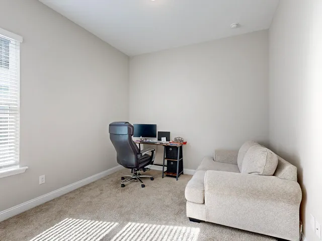a work room with a couch and a window