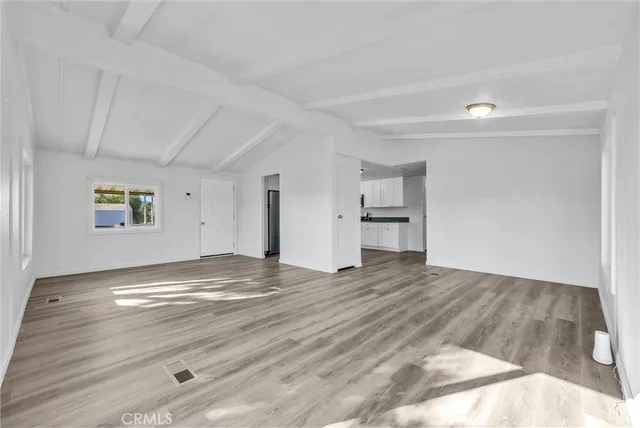 a view of a livingroom with wooden floor and window