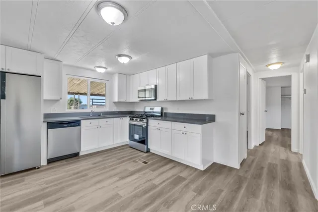 a kitchen with a stove a sink and a microwave