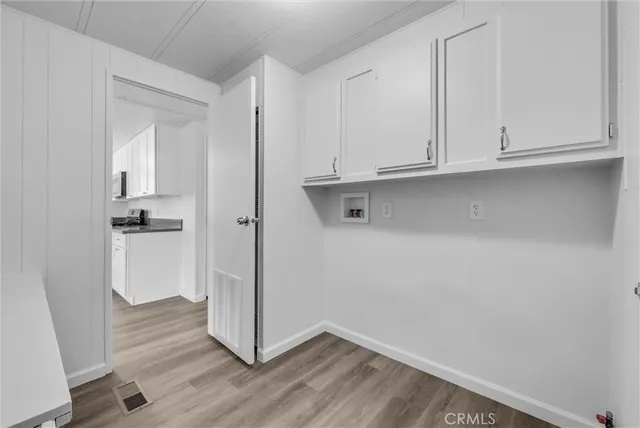 a view white cabinets with wooden floor