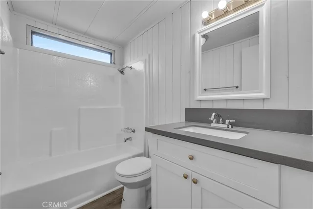 a view of an empty room and wooden floor