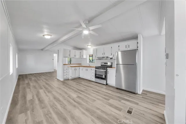 a view of a kitchen with center island and wooden floor