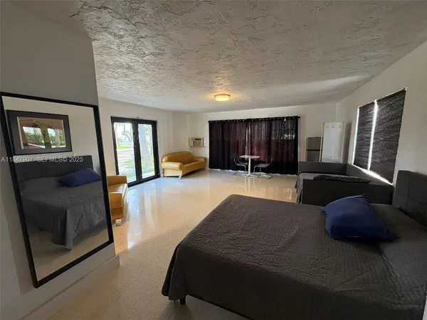 a large bedroom with a large bed and a couch