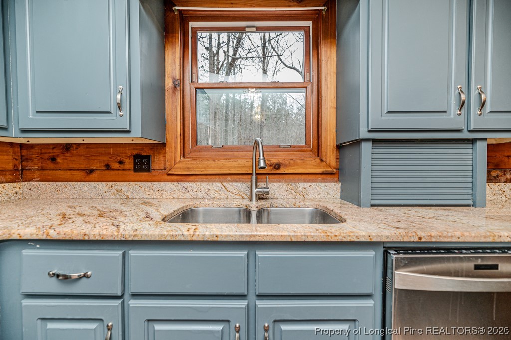 515 Tramway West Road Sanford, NC 27330 - Photo 13 of 38 a kitchen with granite countertop a sink and a window