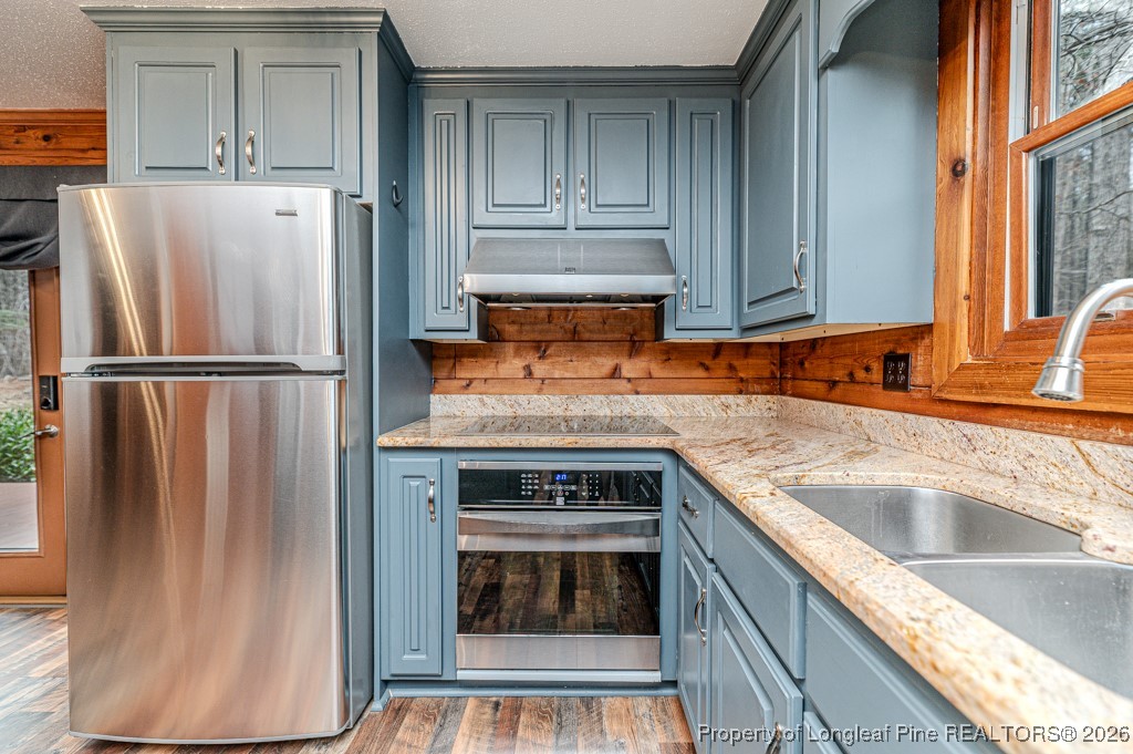 515 Tramway West Road Sanford, NC 27330 - Photo 17 of 38 a kitchen with granite countertop a refrigerator and a sink