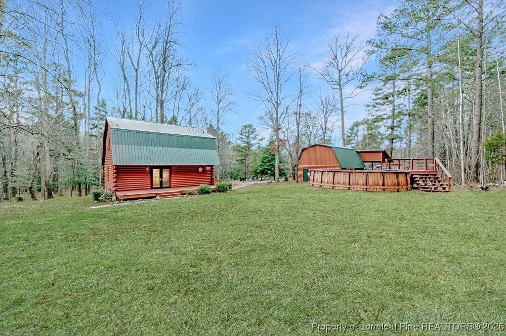 515 Tramway West Road Sanford, NC 27330 - Photo 2 of 38 a view of a backyard with table and chairs and a large tree