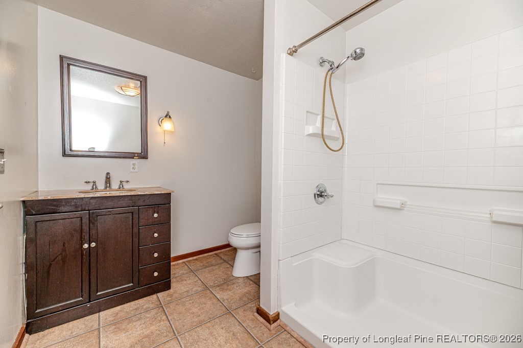 515 Tramway West Road Sanford, NC 27330 - Photo 29 of 38 a bathroom with a granite countertop sink a toilet and shower