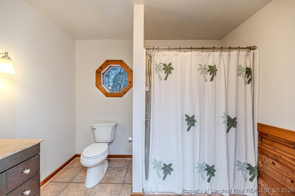 515 Tramway West Road Sanford, NC 27330 - Photo 31 of 38 a bathroom with a toilet a sink and a shower