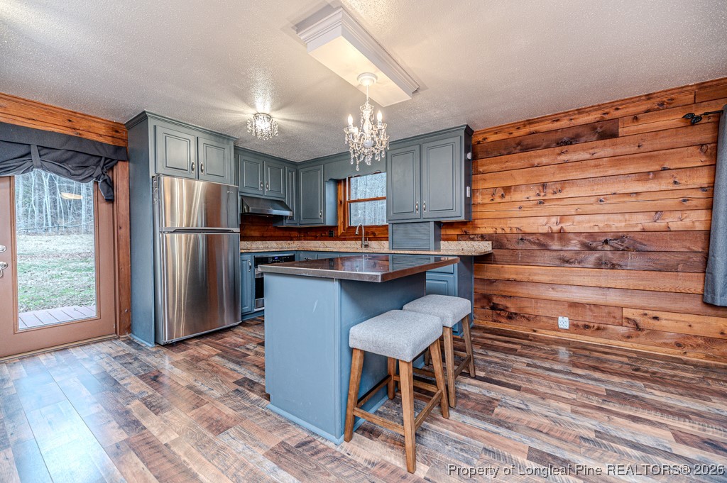 515 Tramway West Road Sanford, NC 27330 - Photo 10 of 38 a kitchen with granite countertop stainless steel appliances and wooden cabinets