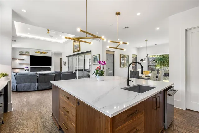 a kitchen with a sink a counter top space appliances and cabinets