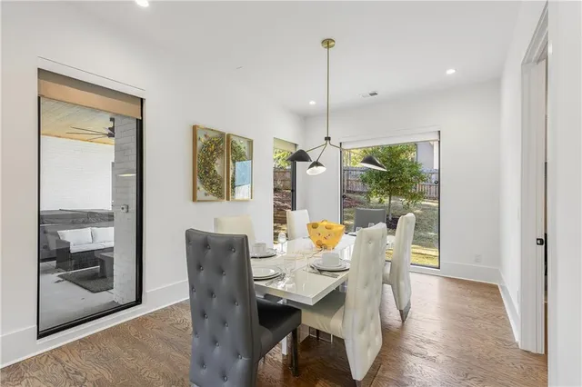 a dining room with furniture and wooden floor