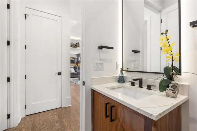 a bathroom with a sink vanity mirror and toilet