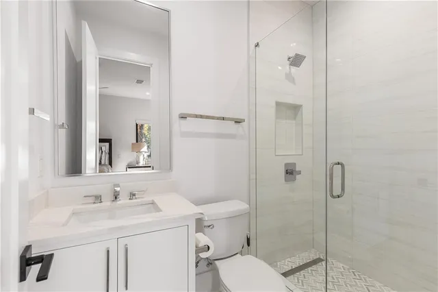 a bedroom with a large bed and a flat tv screen on dresser