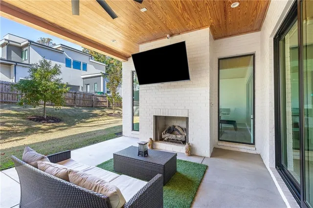 a view of a balcony with two chairs and a potted plant