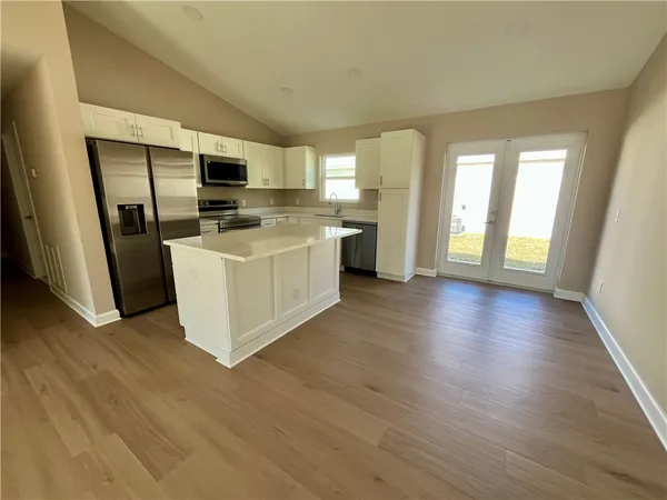 a view of a kitchen with a sink a microwave and refrigerator