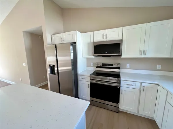 a kitchen with a refrigerator stove and microwave