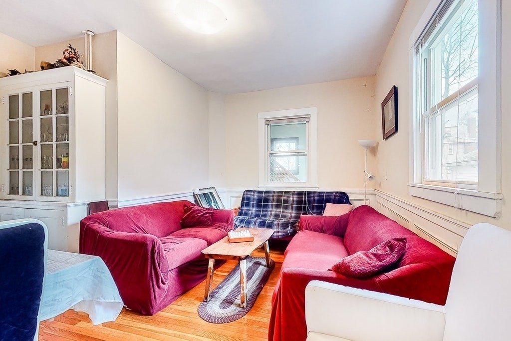 8-10 Allston Street Newton, MA 02465 - Photo 11 of 42 a living room with furniture and a window