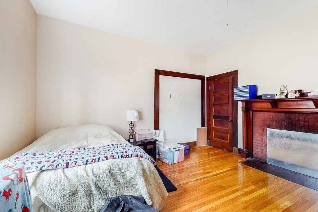8-10 Allston Street Newton, MA 02465 - Photo 12 of 42 a bedroom with a bed and a dresser