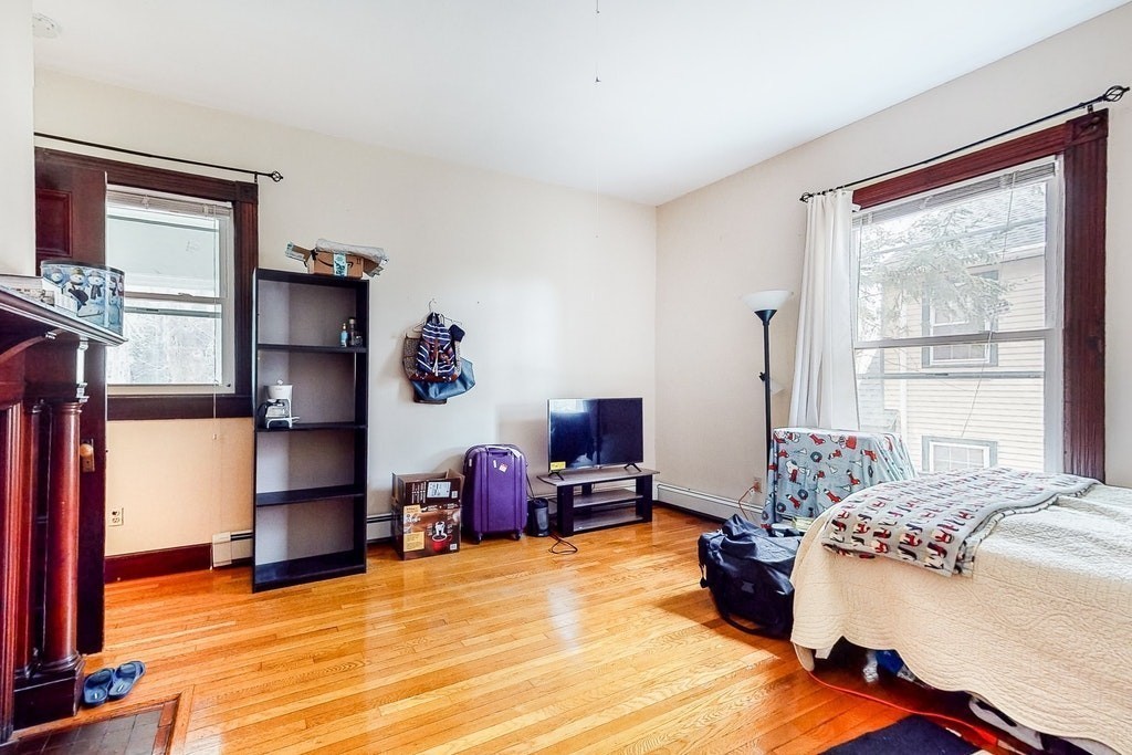 8-10 Allston Street Newton, MA 02465 - Photo 13 of 42 a bed room with a bed and a window