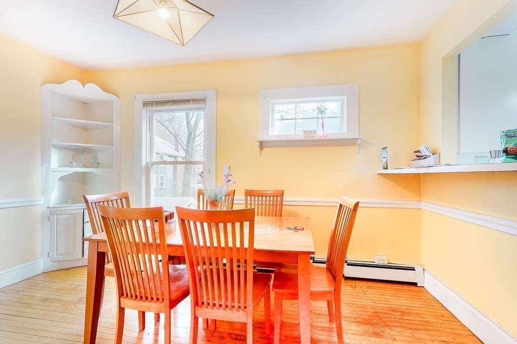 8-10 Allston Street Newton, MA 02465 - Photo 20 of 42 a dining room with furniture and wooden floor