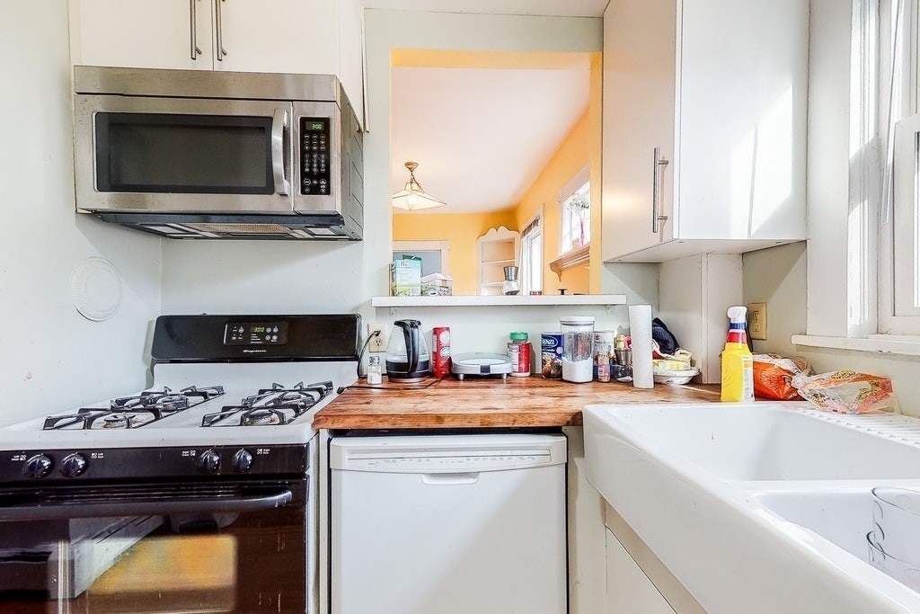 8-10 Allston Street Newton, MA 02465 - Photo 23 of 42 a kitchen with a stove a sink and a microwave