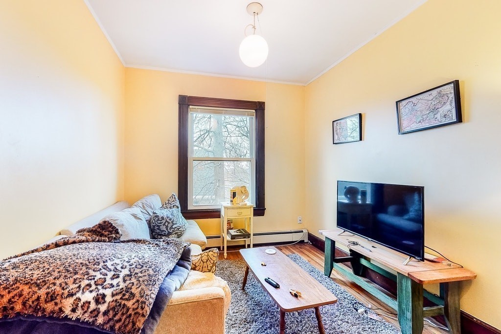 8-10 Allston Street Newton, MA 02465 - Photo 31 of 42 a living room with furniture a rug and a flat screen tv