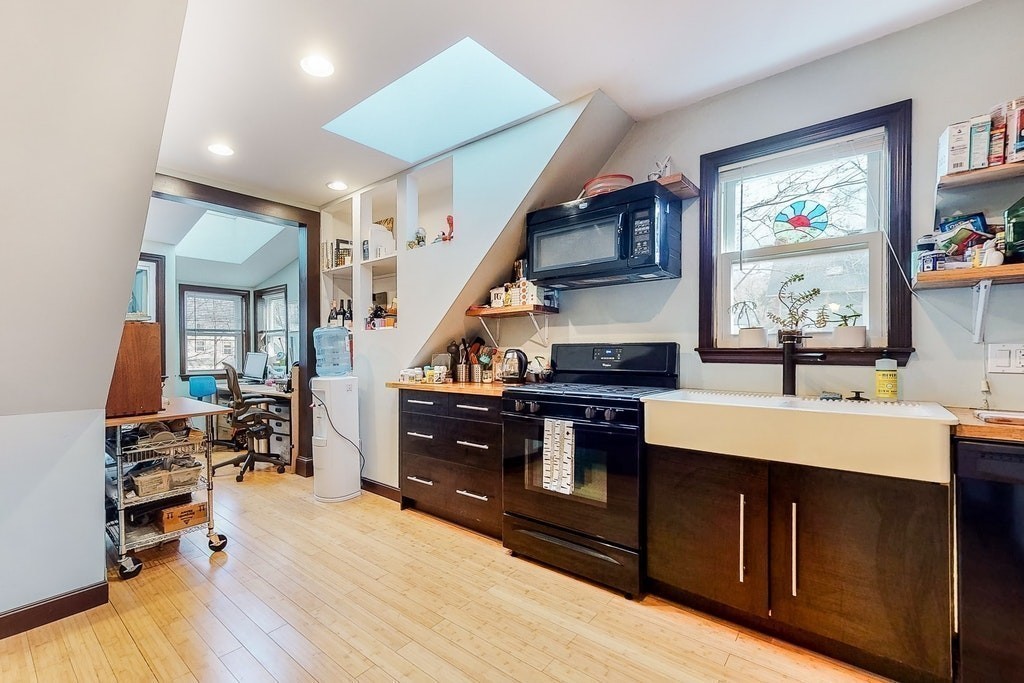 8-10 Allston Street Newton, MA 02465 - Photo 33 of 42 a kitchen with a sink appliances and a dining table