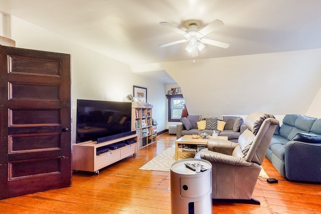 8-10 Allston Street Newton, MA 02465 - Photo 36 of 42 a living room with furniture and a flat screen tv