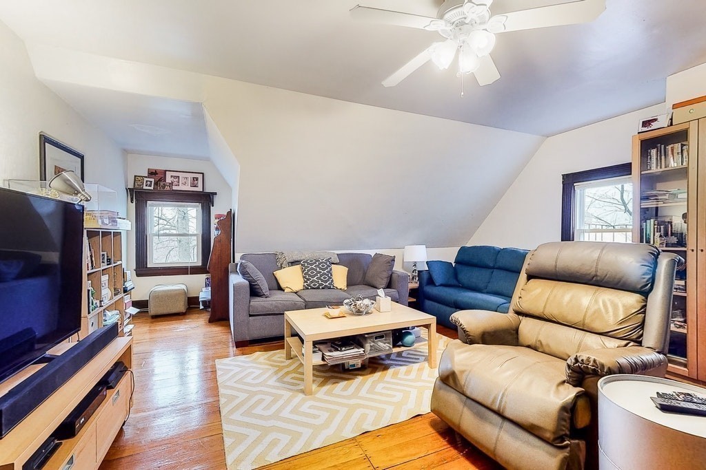 8-10 Allston Street Newton, MA 02465 - Photo 37 of 42 a living room with furniture and a flat screen tv