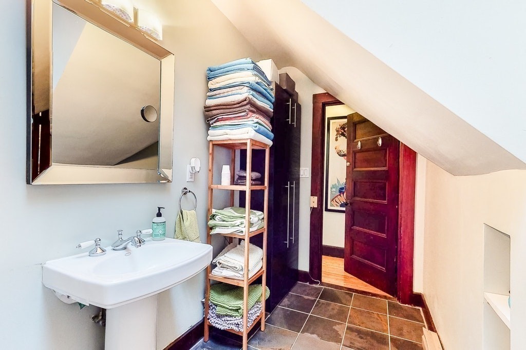 8-10 Allston Street Newton, MA 02465 - Photo 41 of 42 a bathroom with a sink and a mirror