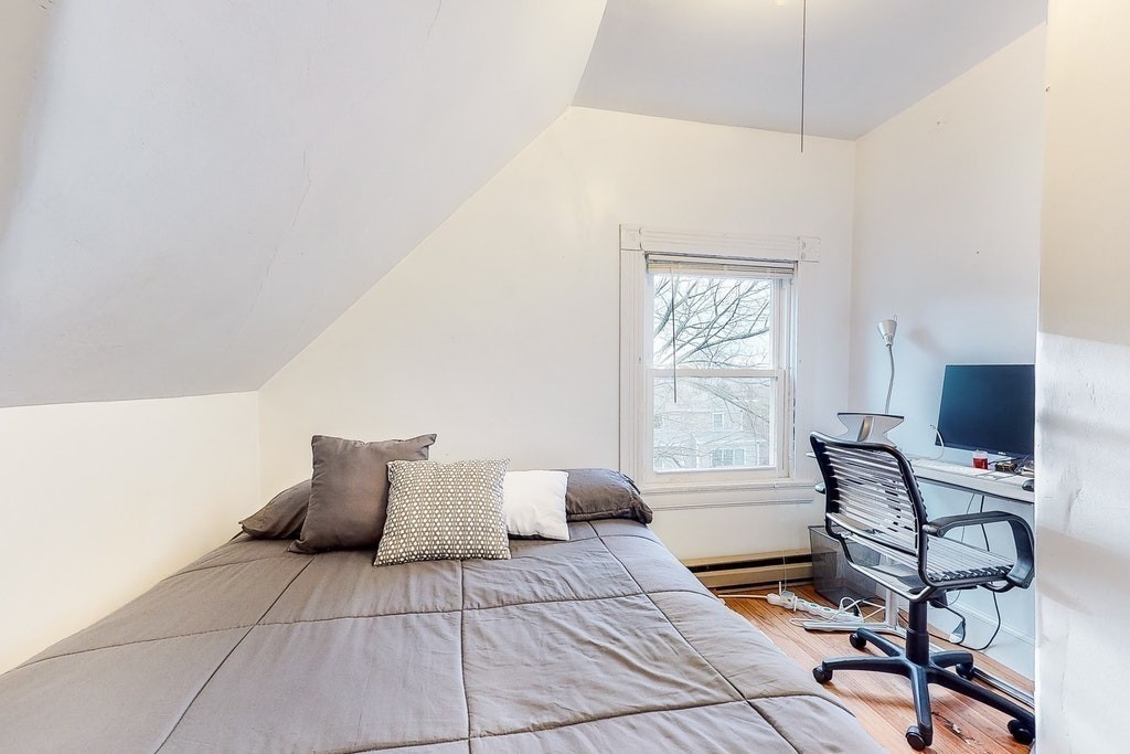 8-10 Allston Street Newton, MA 02465 - Photo 42 of 42 a bedroom with a bed and chair