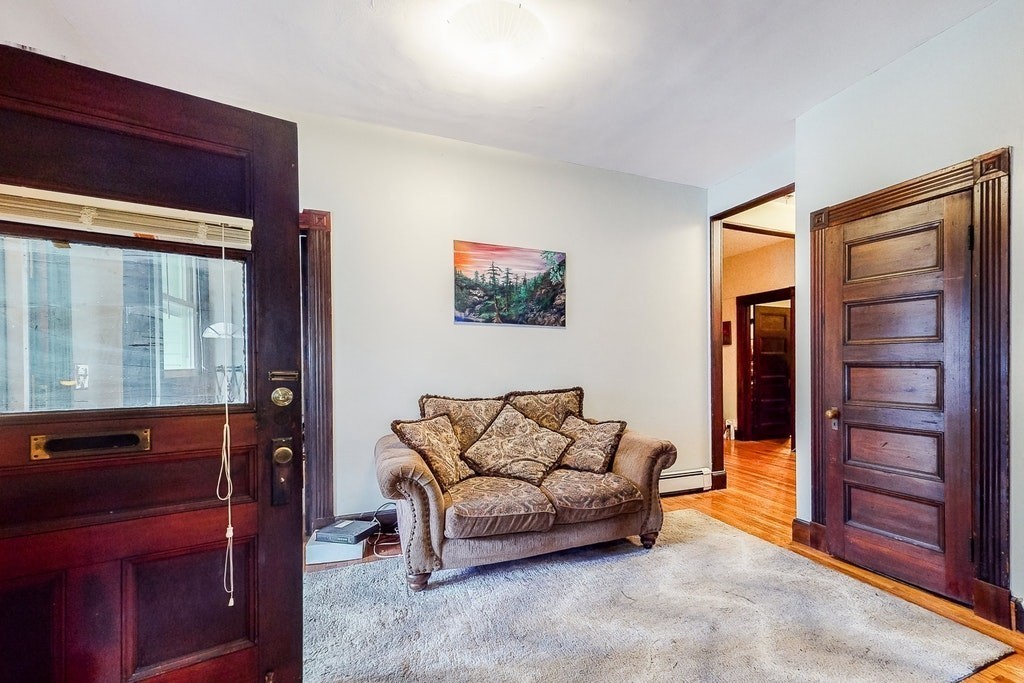 8-10 Allston Street Newton, MA 02465 - Photo 9 of 42 a living room with furniture and a window