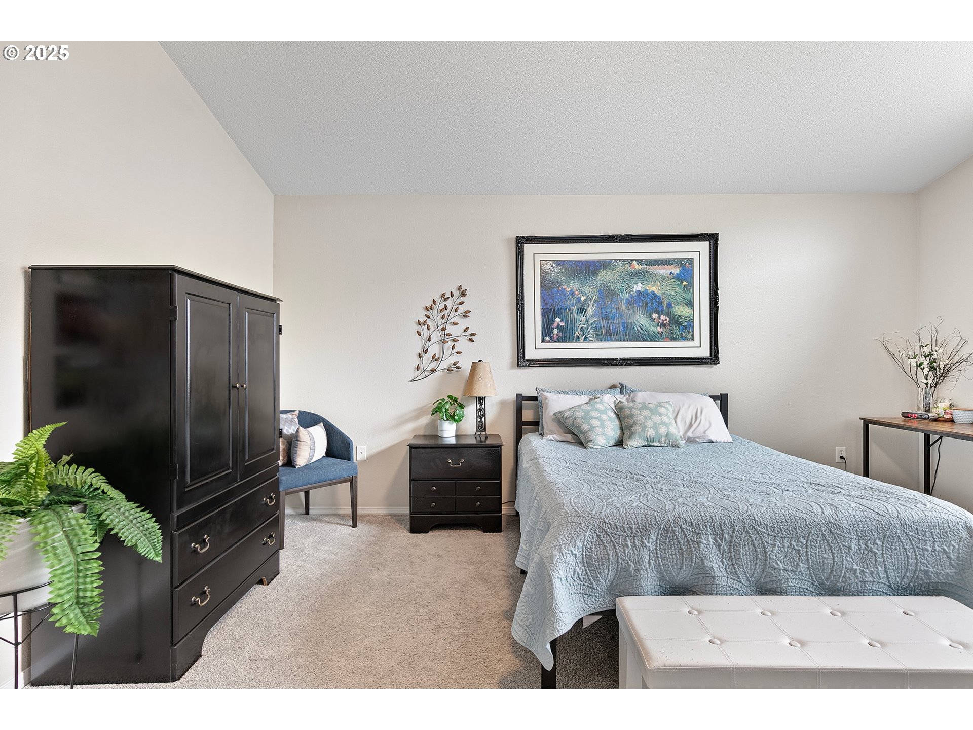 30366 Southwest Ruth Street, Unit 70 Wilsonville, OR 97070 - Photo 25 of 46 a bedroom with a bed and a flat screen tv