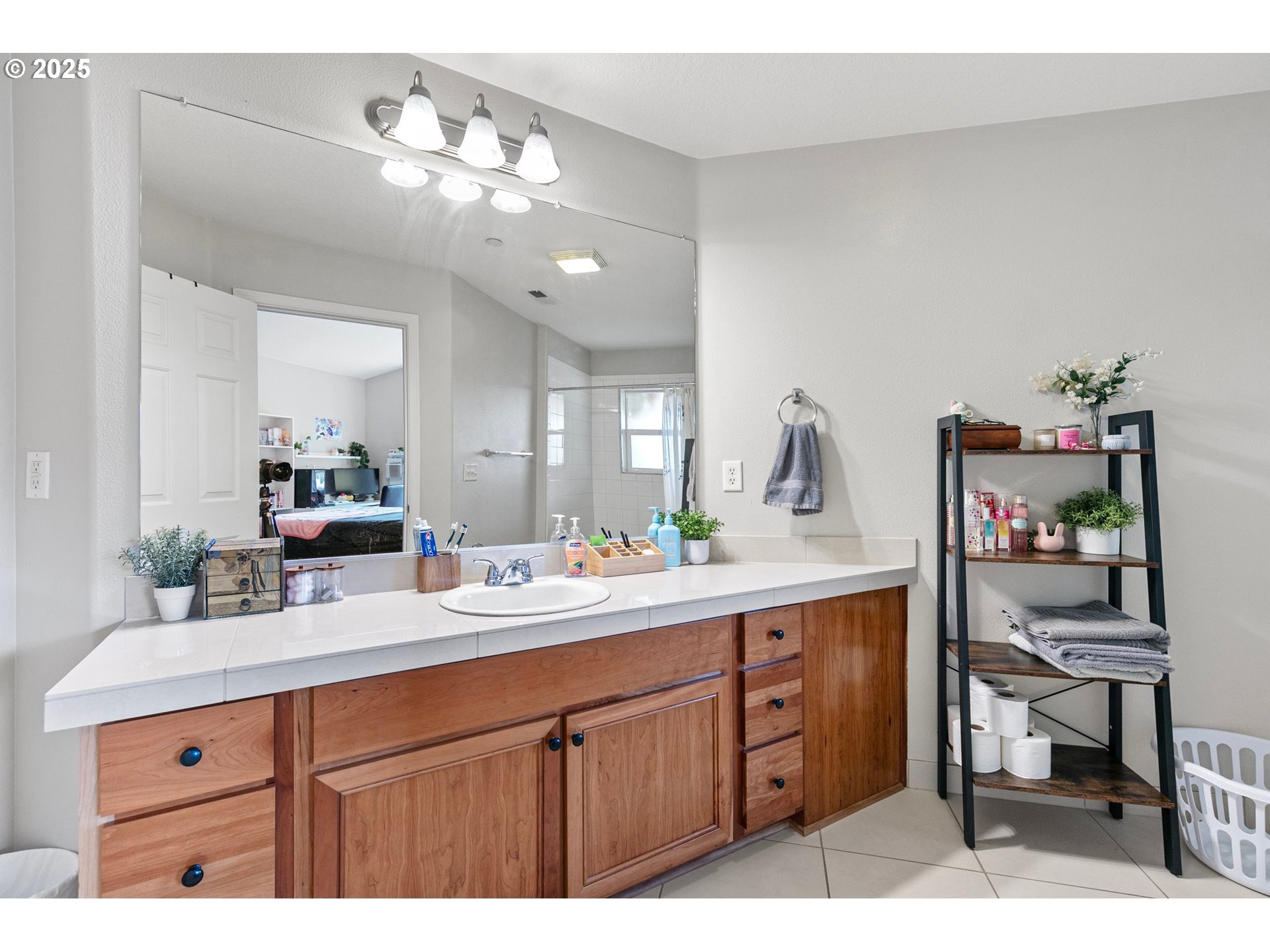 30366 Southwest Ruth Street, Unit 70 Wilsonville, OR 97070 - Photo 35 of 46 a spacious bathroom with a granite countertop sink a mirror and a