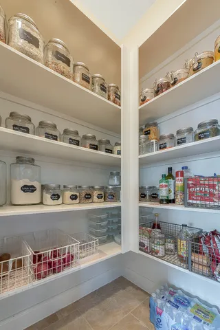 a cabinet with granite countertop lots of different kinds of food