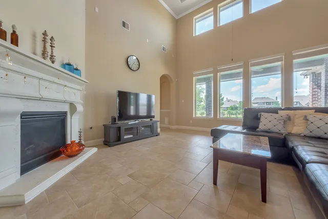a living room with furniture a flat screen tv and a fireplace
