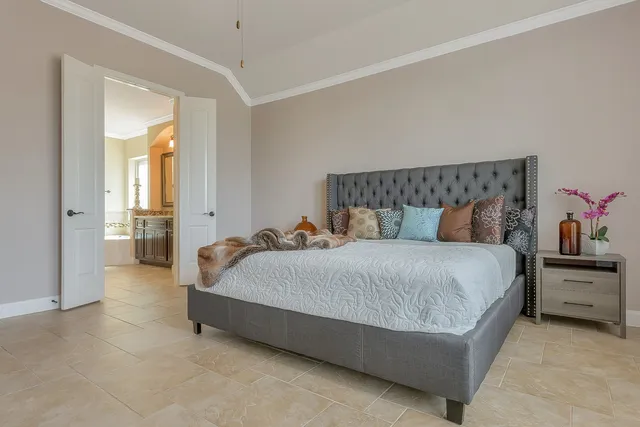 a spacious bedroom with a bed and a couch