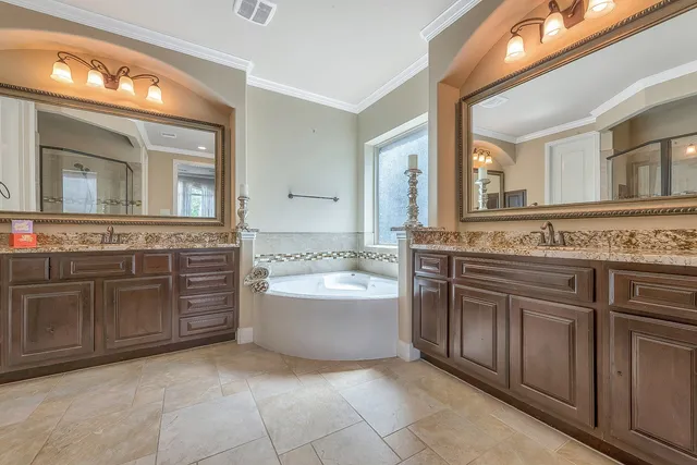 a spacious bathroom with a granite countertop sink and a mirror