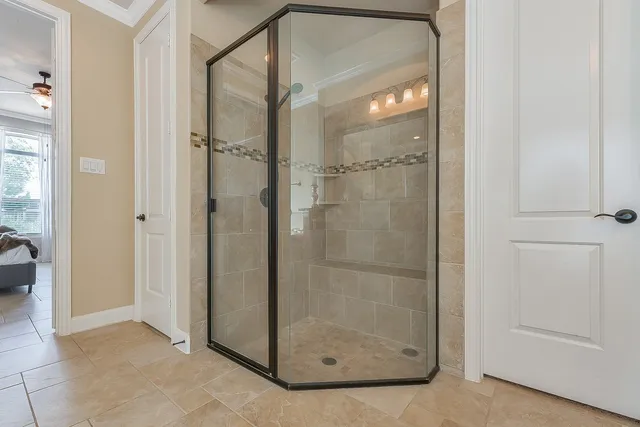 a bathroom with a glass shower door