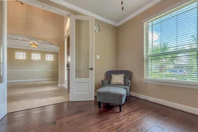 a room with chair table and wooden floor
