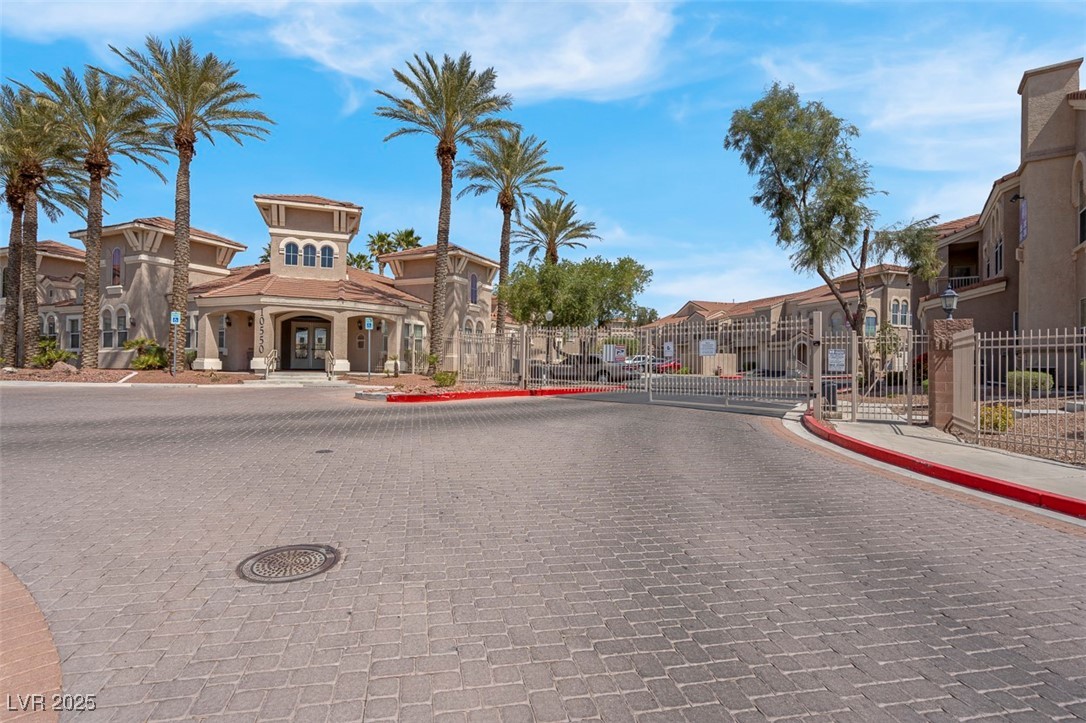 10550 West Alexander Road, Unit 2210 Las Vegas, NV 89129 - Photo 28 of 29 View of road with a residential view, sidewalks, a gate, and curbs