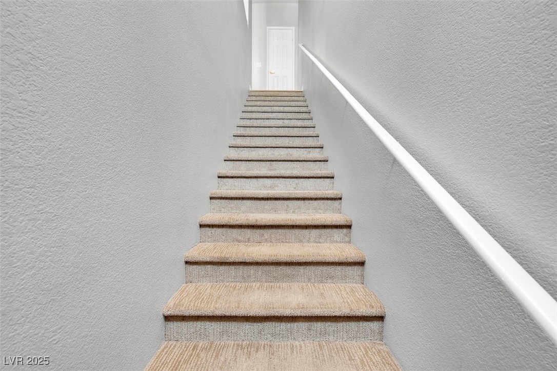 10550 West Alexander Road, Unit 2210 Las Vegas, NV 89129 - Photo 4 of 29 Staircase featuring a textured wall